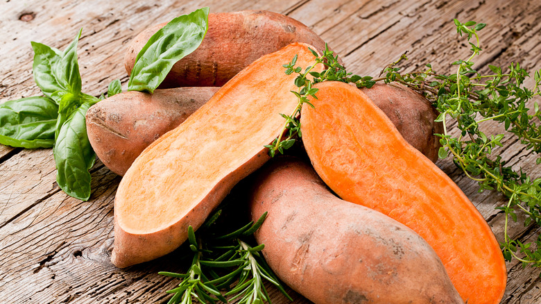 Sweet potatoes on a wooden background