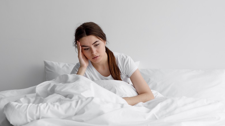 A woman wakes up tired