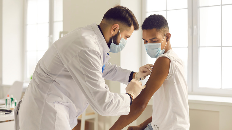 A young man gets a vaccine