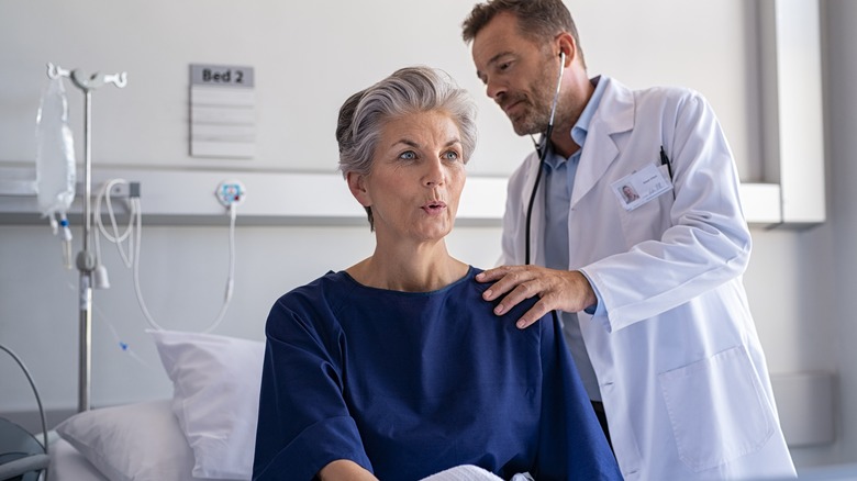 doctor checking patient