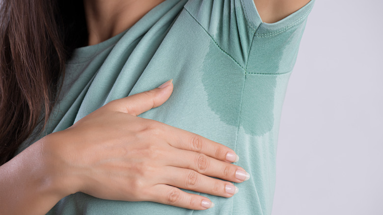woman with wet stain under her armpit 