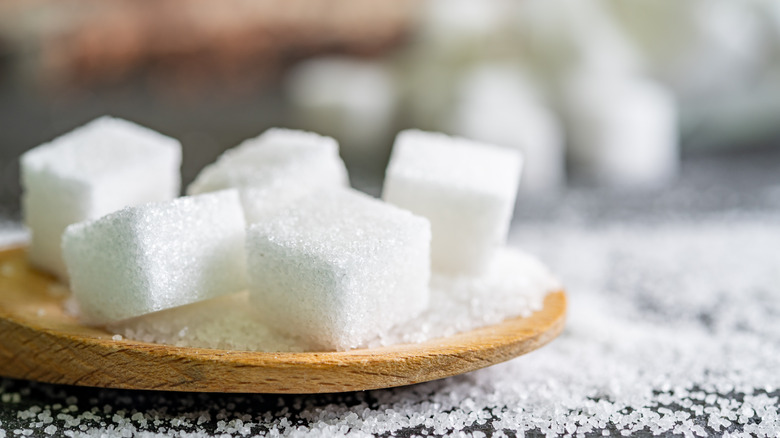 Sugar cubes on wooden plate