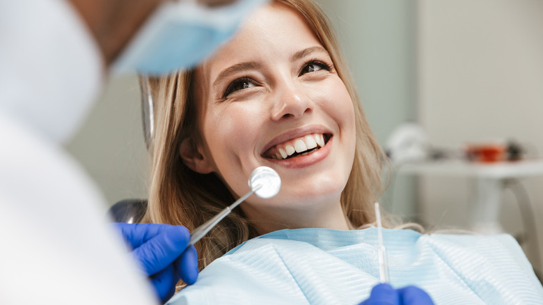 Woman smiles in dentist chair