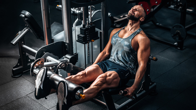 Man on leg machine at the gym