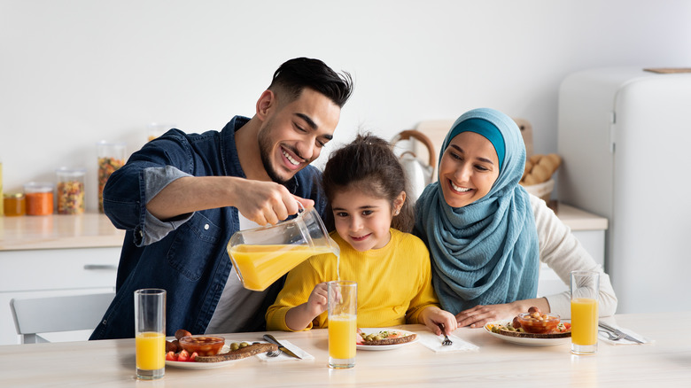 Family enjoying oj with breakfast