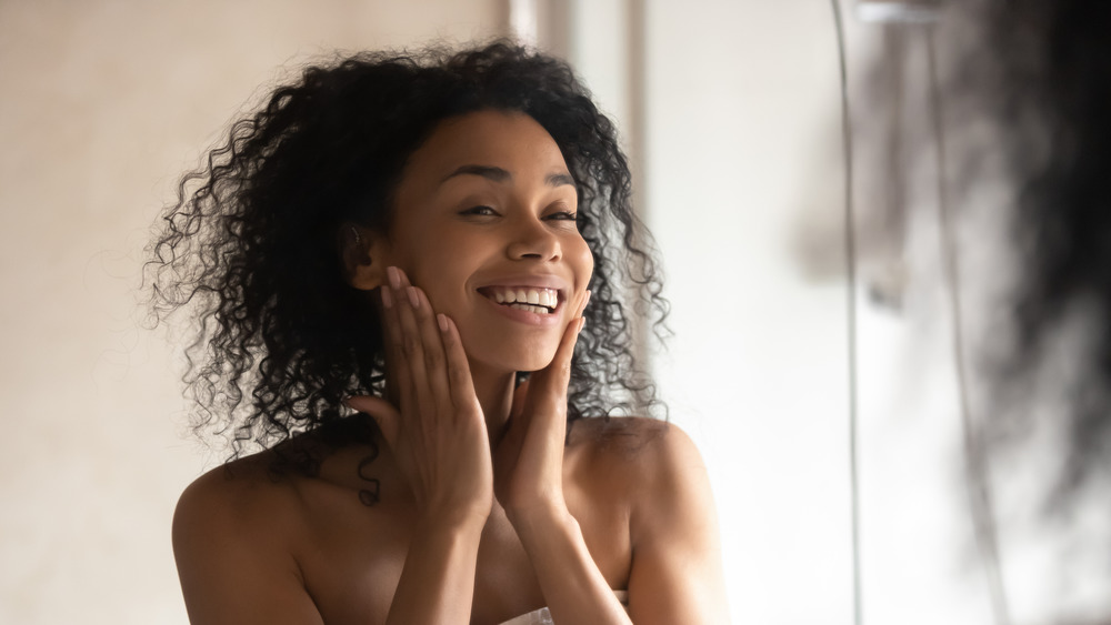 Woman looking at her skin