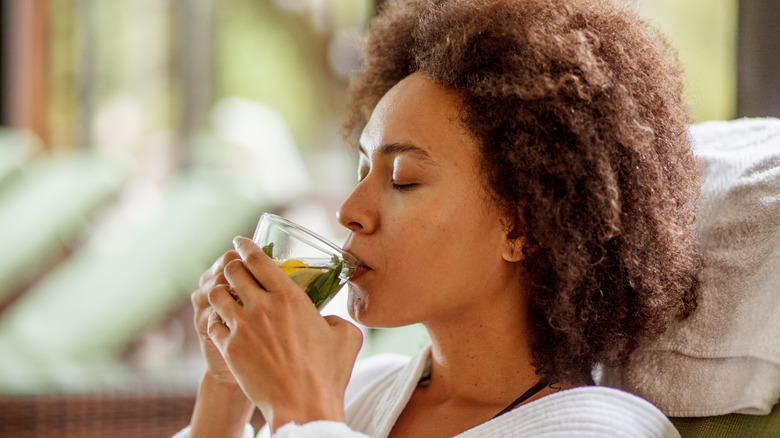 woman drinking cup of herbal tea