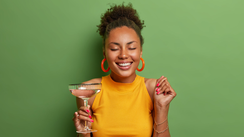 Woman smiling with cocktail glass