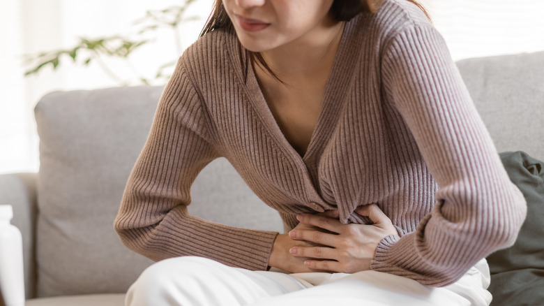 woman holding stomach