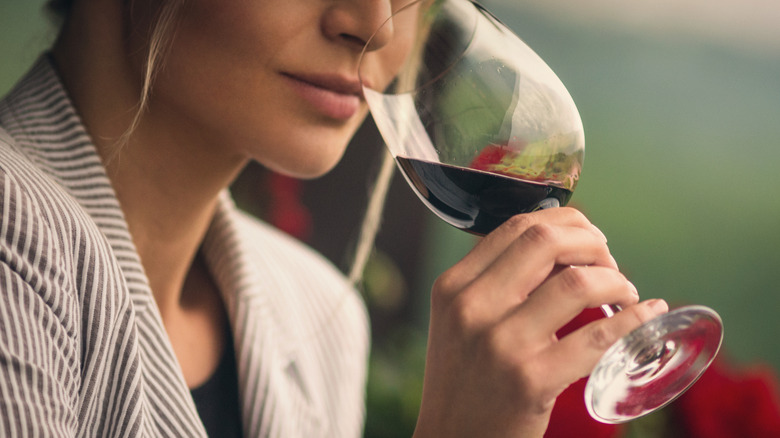 Woman taking wine from fridge