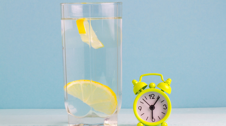 glass cup of water with lemon slice