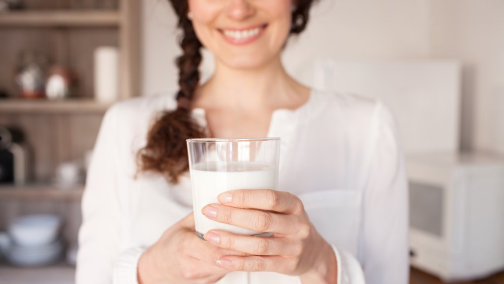woman holding glass of milk