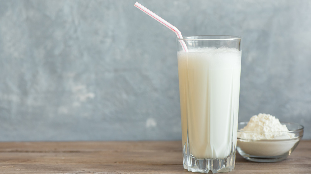 Vanilla protein shake next to the powdered form 