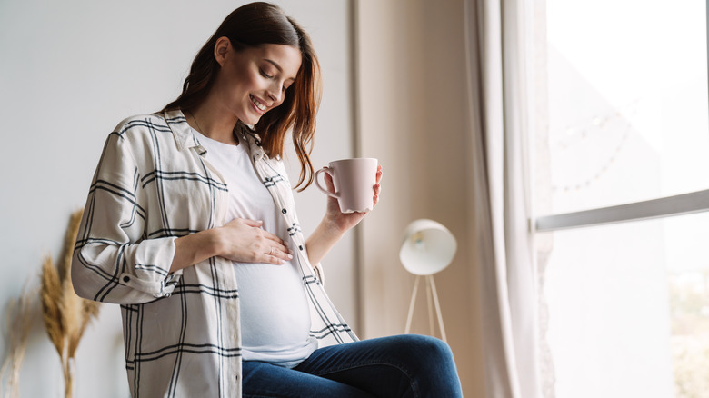 Pregnant woman drinking coffee