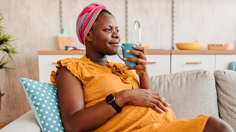 Pregnant woman holding tea mug