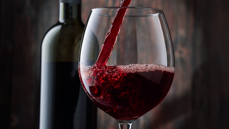 Red wine being poured into a wine glass 