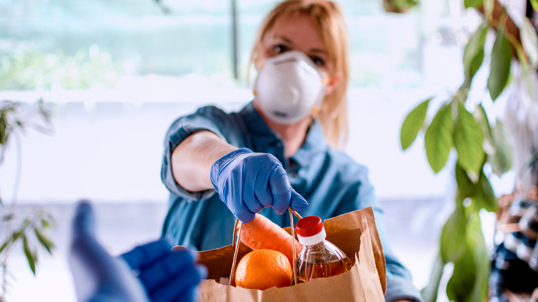 Woman with latex gloves and food