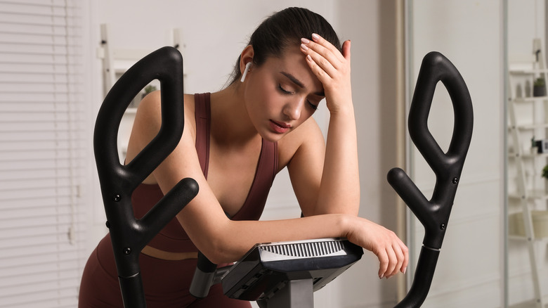 Tired woman on exercise machine