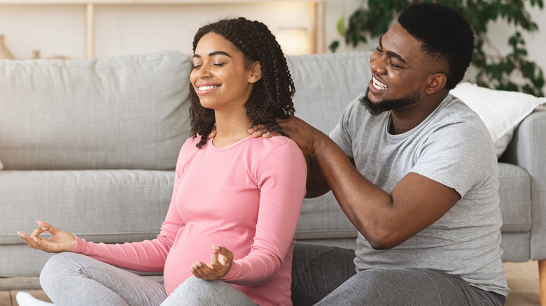 Man giving pregnant woman massage