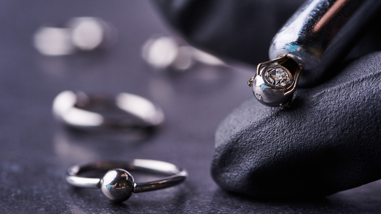 Piercer holding body jewelry