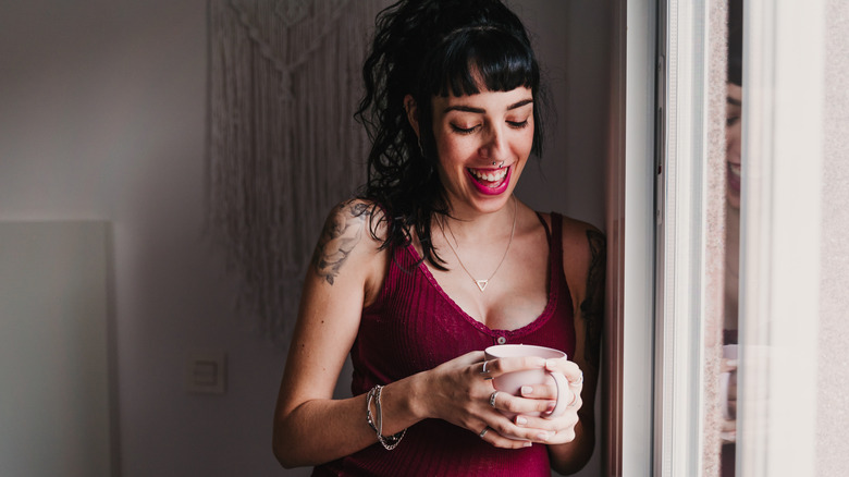 portrait of a young pregnant woman with a shoulder tattoo 