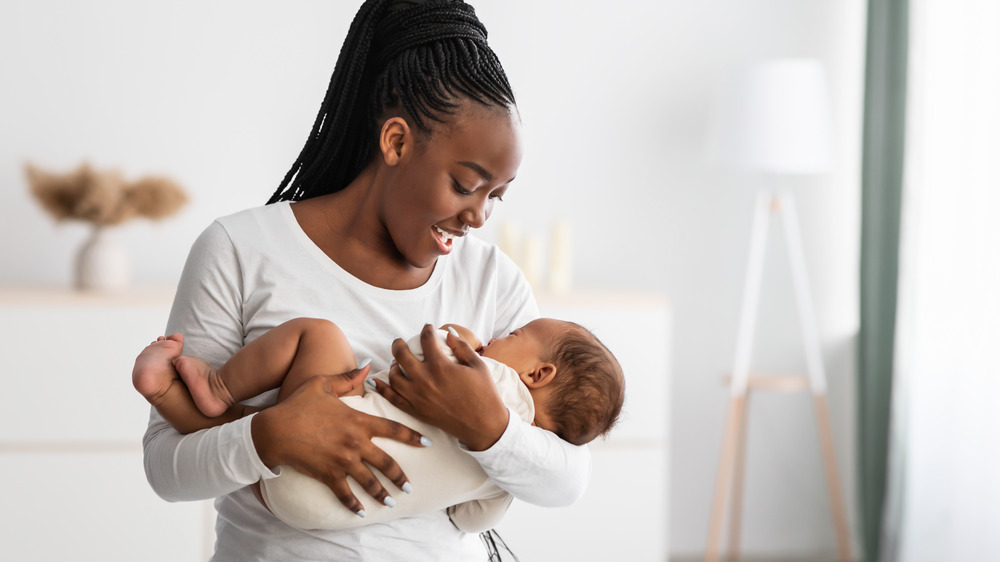 Young mother breastfeeding baby