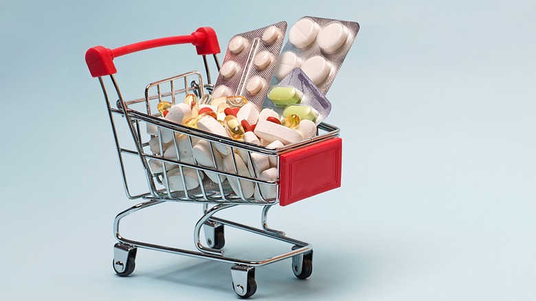 toy shopping cart filled with pills