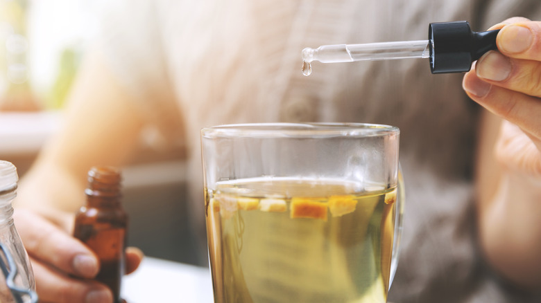 woman mixing cbd into drink