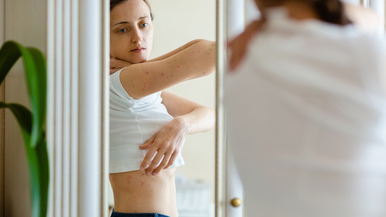 woman looking at herself in the mirror