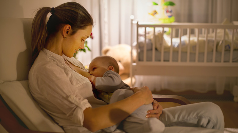 Mom breastfeeding baby at night