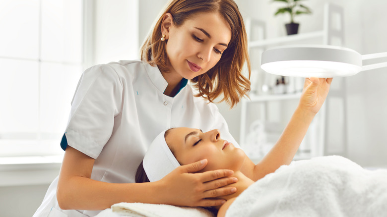dermatologist working on client