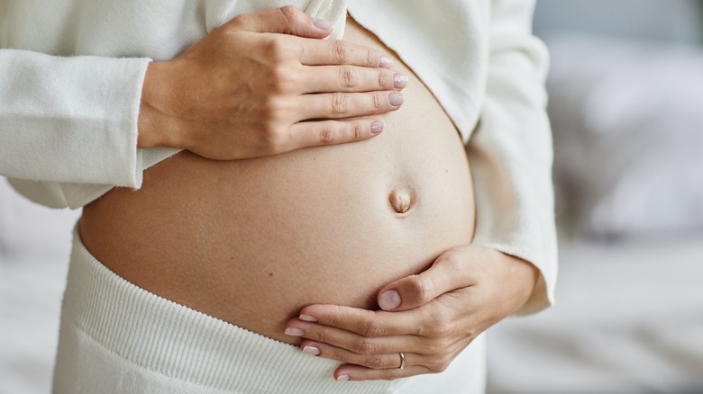 pregnant woman holding belly