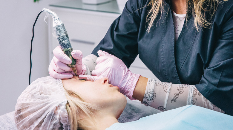 cosmetic tattoo artist applying semi-permanent eyeliner 