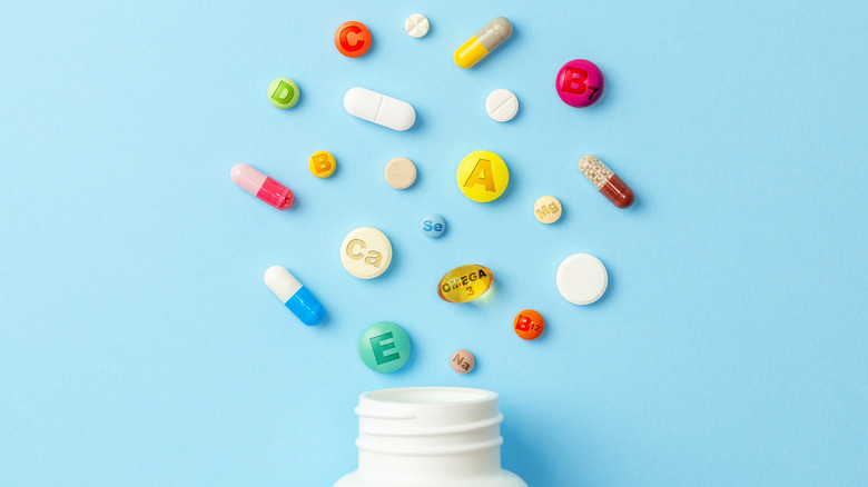Flat lay of bottle and vitamins