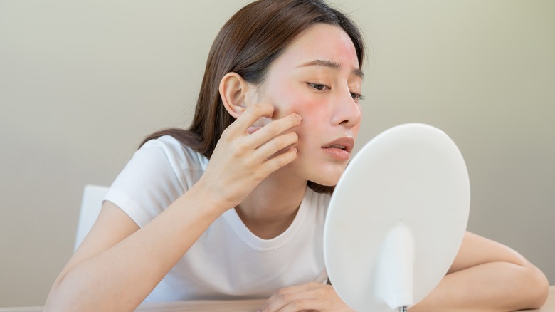 woman looking at irritated skin