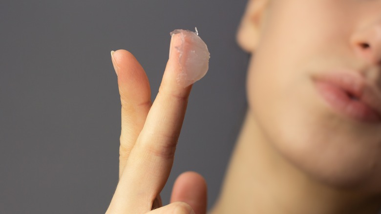 woman with vaseline on finger