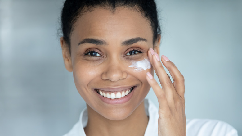 Woman applying face cream