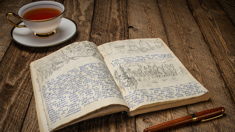 notebook next to a cup of tea