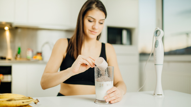 woman mixing a protein drink