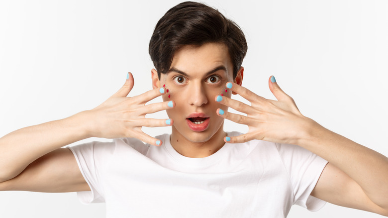 Man with blue painted nails