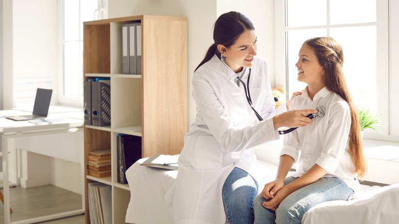 Doctor checking patient with stethoscope