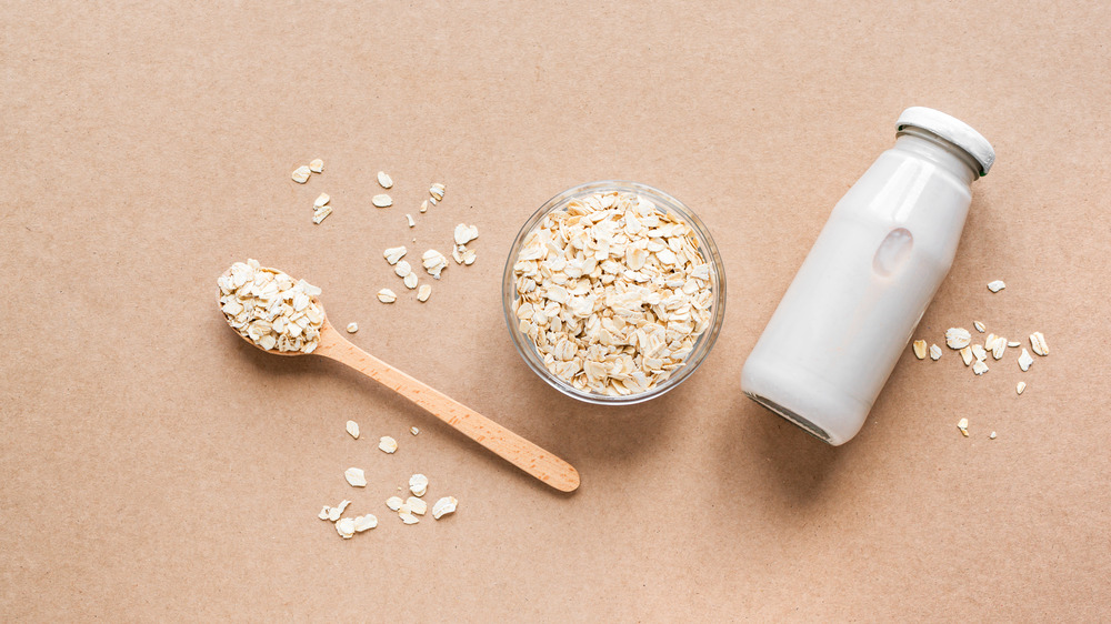 Oats and milk bottle on table