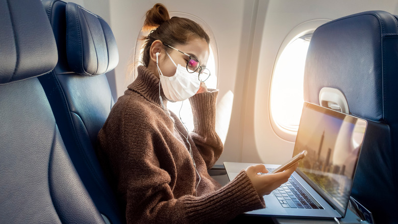 Woman wearing mask on plane