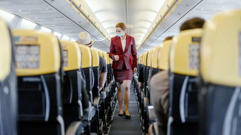 Flight attendant wearing mask