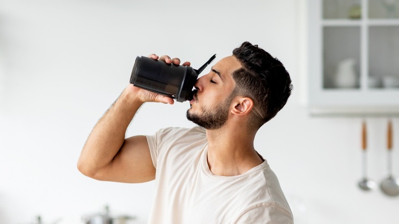 man drinks protein shake 
