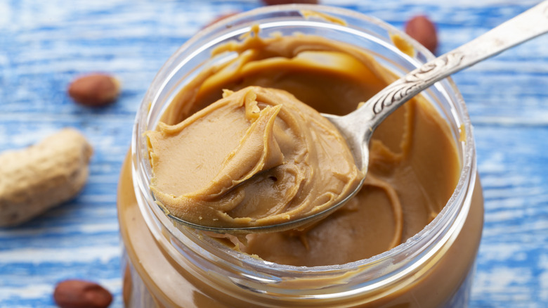 Jar of peanut butter with spoon 