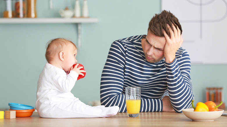 Anxious-looking dad around his toddler 