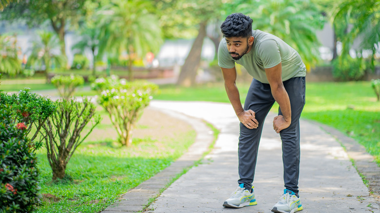 Young man out of breath in park