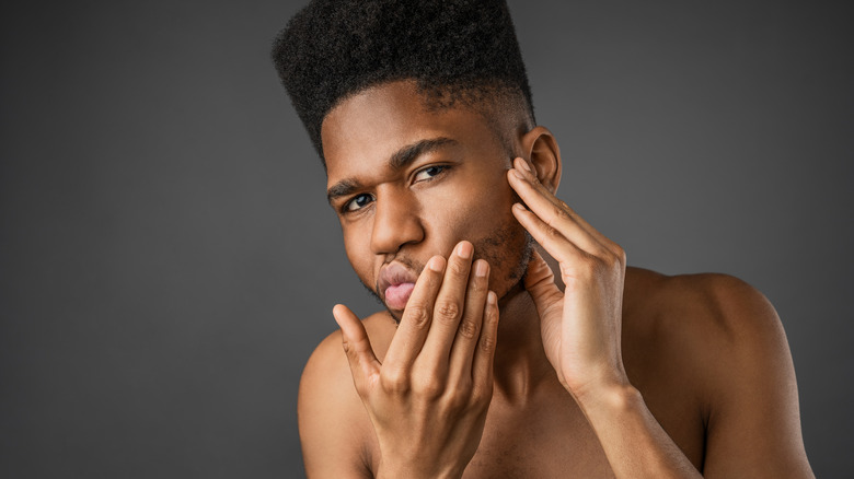 man examining face