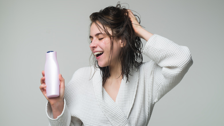 Woman holding bottle of conditioner 